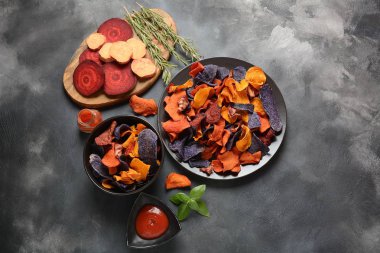 Fırında sebze cips- garnet tatlı patates, mor tatlı patates, havuç ve pancar. Glutensiz, sütsüz ve vegan. Sağlıklı gıda kavramı