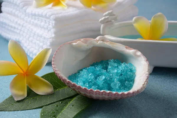 Spa and body care products. Aromatic blue bath Dead Sea Salt on the blue  background. Natural ingredients for homemade body salt scrub. Dead Sea cosmetics. Beauty skin care. Spa treatment.