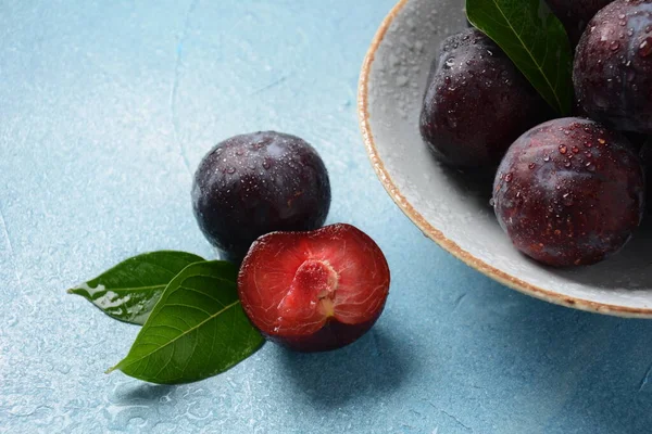 Juicy plums in a plate. Fresh Blue plums.