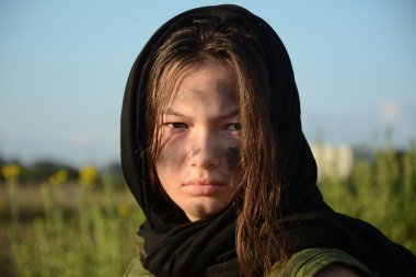 Kıyamet sonrası çöl arazisinde genç bir milis askerin portresi. Kentsel savaş ve çorak arazi.