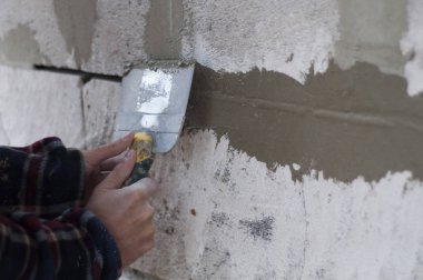 adam duvar kaymağını bir spatula ile