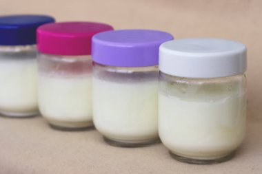 Renkli kapaklı cam bir kapta taze doğal ev yapımı organik yoğurt Bölümü