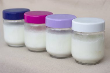 Renkli kapaklı cam bir kapta taze doğal ev yapımı organik yoğurt Bölümü