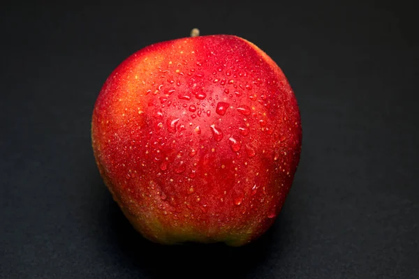 Red apple on a black table background
