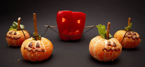 Boss employee manipulating his staff in business concept. halloween peppers and tangerines with selective focus