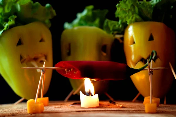 Halloween food peppers. Composition of sacrifice, burning and eating. Grilled vegetables. Vegetarianism