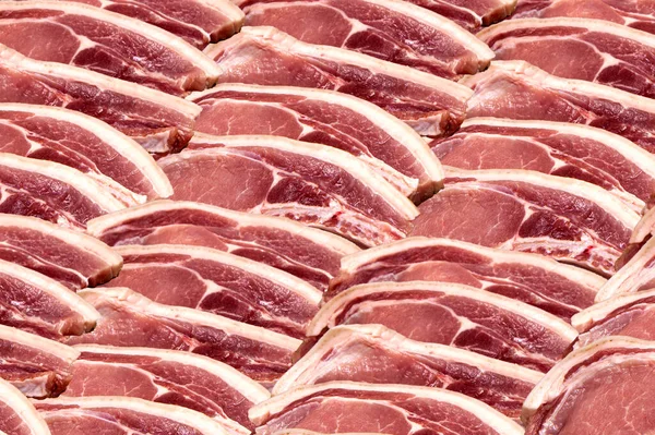 raw meat Texture, Background. Closeup of a Piece of Sirloin for Steak. many slices of meat on top of each other