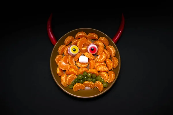 Scary halloween food vampire or demon monster face for celebration party decoration. Children\'s holiday food made from fruits and sweets
