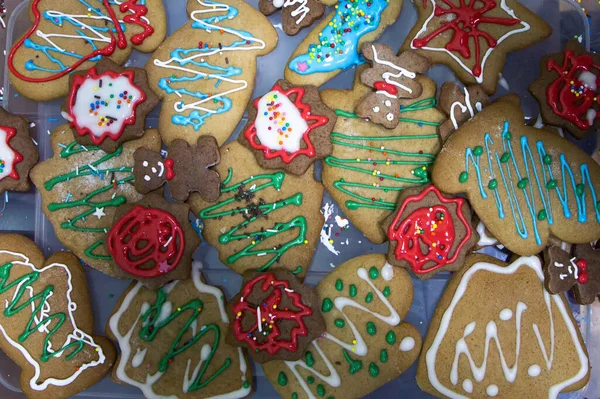 Christmas homemade gingerbread cookies decorated colored icing for new year day, christmas, winter holiday food. inept children\'s drawings on gingerbread