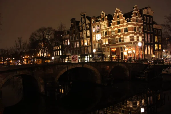 famous bridge in amsterdam. romantic night landscape. a bit of haze and fog makes the magic channel