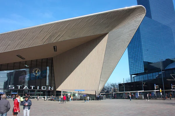 Güzel güneşli bir gün Hollanda 'ya bir gezi. Mavi gökyüzü ve geometrik yapılar ve uzun binalar hayran Rotterdam Merkez Istasyonu meydanında yürümek