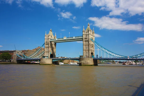 Slavný londýnský most na modrém nebeském letním dni. Klidná voda řeky Temži — Stock fotografie