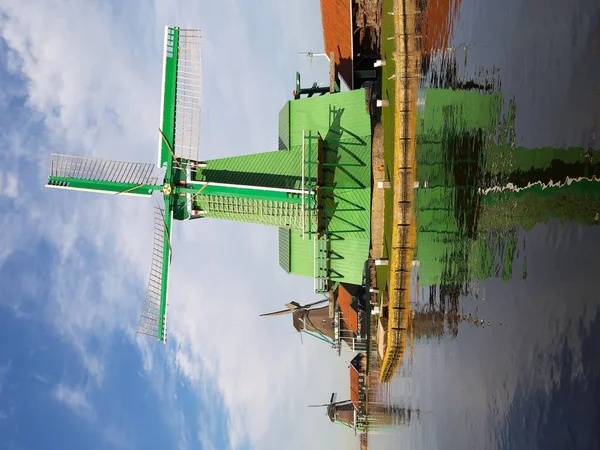 The Dutch Dutch suburb of Zaansche Schans. The water channels, the serene climate and the typical windmills.