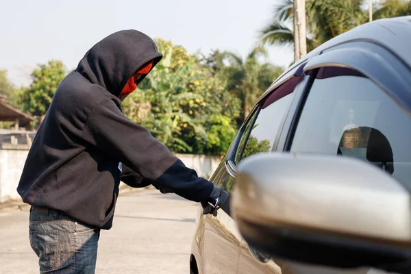 Male thief tries to steal a car. Car theft concept