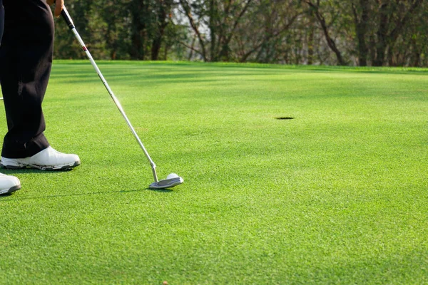 Man playing golf on a golf course.