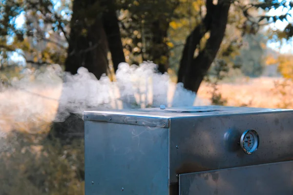 steam coming out of smoker in natural landscape