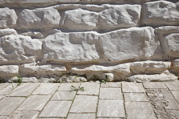 Detail of natural stone wall cladding. Concrete or cobble gray pavement slabs or stones for floor, wall or path. Traditional fence, court, backyard or road paving.