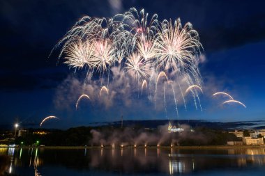 Su üzerinde gece gökyüzünde güzel piroteknik havai fişek gösterisi. Kutlama.