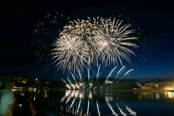 Su üzerinde gece gökyüzünde güzel piroteknik havai fişek gösterisi. Kutlama.