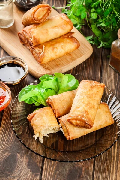 Spring rolls with chicken and vegetables served with sweet chili sauce or soy sauce. Asian cuisine.