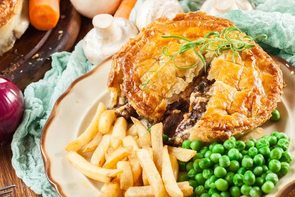 Homemade beef stew pie with french fries. Meat in puff pastry