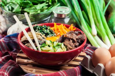 Bibimbap - rice with beef and vegetables. Traditional Korean dish. clipart