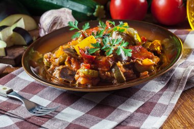 Ratatouille, delicious vegetarian stew. Dish made of zucchini, eggplant, bell peppers, onions, garlic and tomatoes. Traditional french foo clipart
