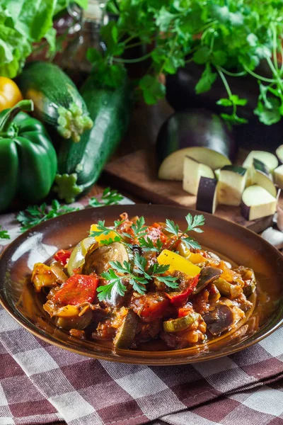 Ratatouille, delicious vegetarian stew. Dish made of zucchini, eggplant, bell peppers, onions, garlic and tomatoes. Traditional french foo