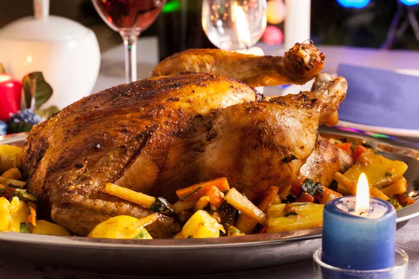 Baked whole chicken for Christmas dinner on festive table