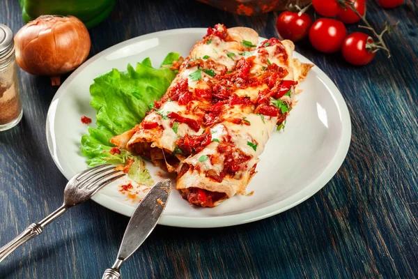 Traditional mexican enchiladas with chicken meat, spicy tomato sauce and cheese on a plate. Mexican cuisine. — Stock Image Traditional Mexican Enchiladas Chicken Meat Spicy Tomato Sauce Cheese Plate Royalty Free Stock Photos
