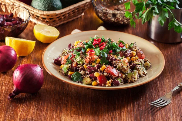 Mexican salad with quinoa, red beans, avocado, corn and tomatoes