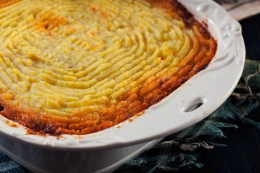Shepherd's pie or cottage pie. Minced beef meat and vegetables with mashed potatoes in casserole dish clipart