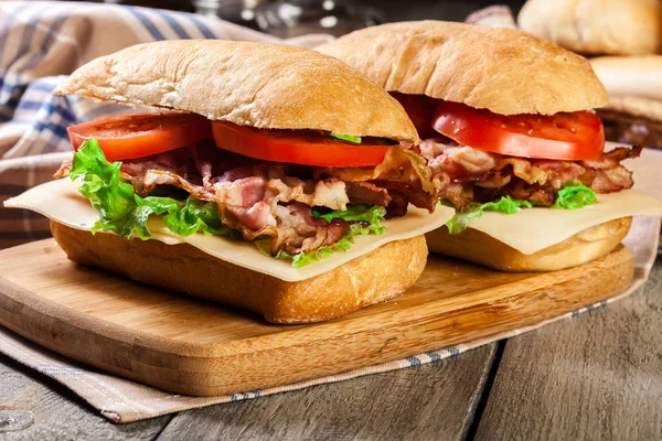 Ciabatta sandwich with smoked bacon and other — Stock Photo, Image