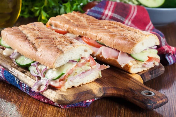 Toasted sandwiches with ham, cheese and vegetables — Stock Photo, Image