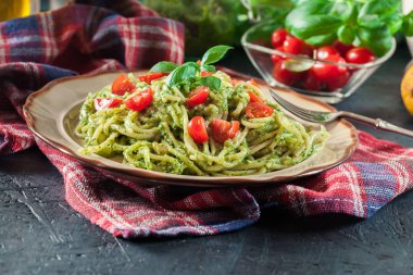 Vegetarian pasta spaghetti with basil pesto and cherry tomatoes clipart
