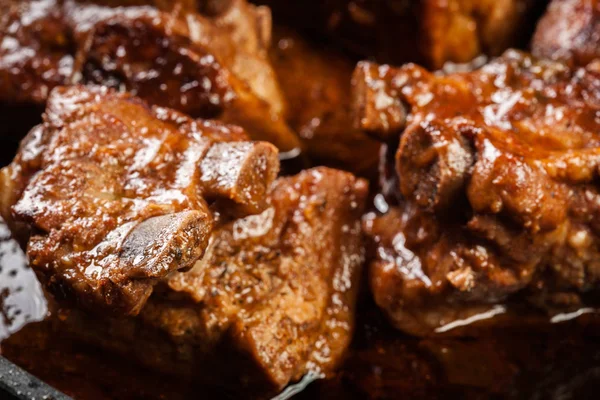 Pork spare ribs on dish in own sauce — Stock Photo, Image