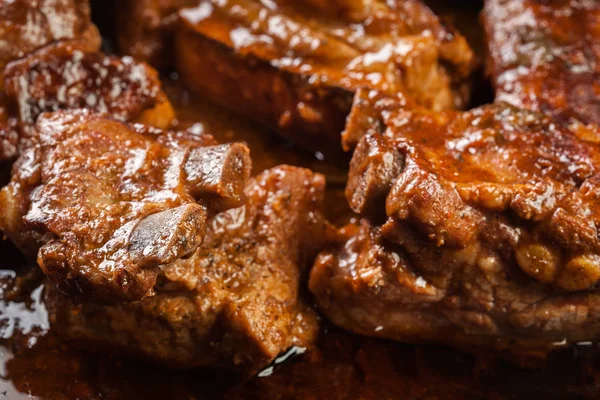 Pork spare ribs on dish in own sauce — Stock Photo, Image