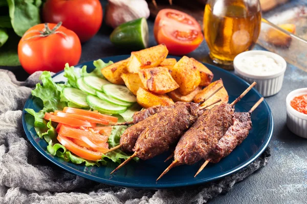 Grilled shish kebab served with fried potatoes — Stock Photo, Image