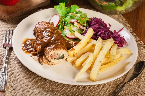 Pork roulade with french fries with salad — Stock Photo, Image