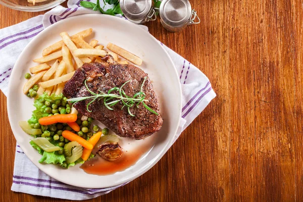 Beef steak served with baked potatoes — Stock Photo, Image