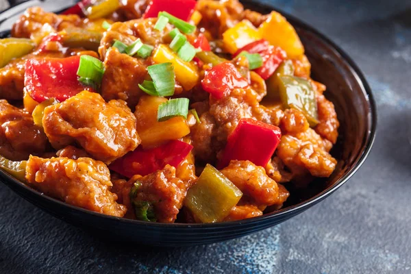 Sweet and sour chicken with colorful bell pepper on a plate — Stock Photo, Image