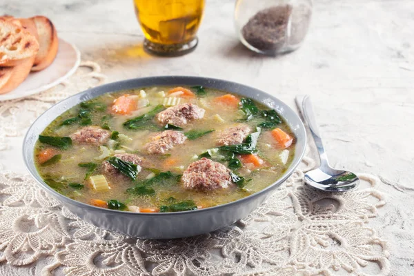 Italian wedding soup with meatballs and vegetables