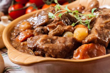 Beef Bourguignon stew served with baguette clipart
