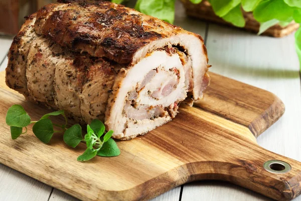 Roasted pork roll stuffed with other meat and dried tomatoes — Stock Photo, Image