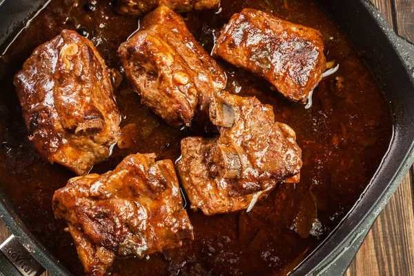 Pork spare ribs on dish in own sauce — Stock Photo, Image