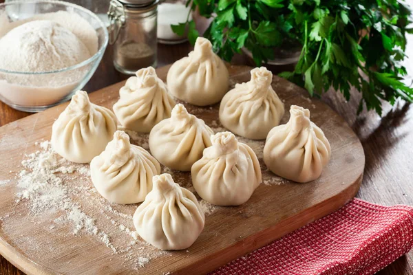 Bolinhos de massa georgianos em bruto - Khinkali (Chinkali) com carne picada e ervas — Fotografia de Stock