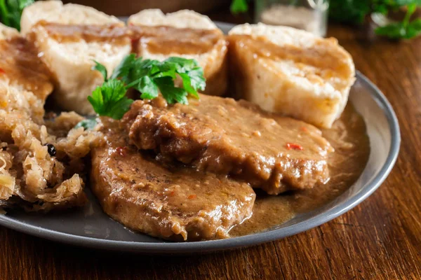 Pork loin in gravy with bread dumplings and sauerkraut — Stock Photo, Image