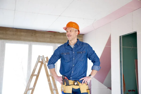 Portrait Thinking Handyman Standing Hand His Chin Construction Site — Stock Photo, Image
