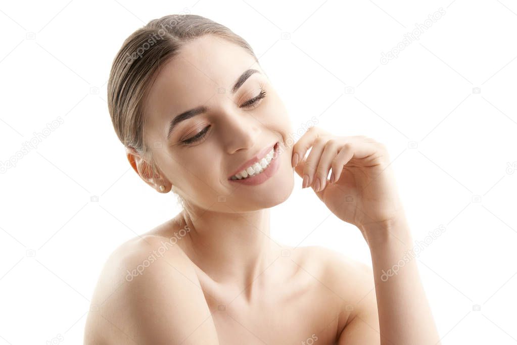 Close-up portrait of beautiful woman with perfect skin posing at isolated white background. 