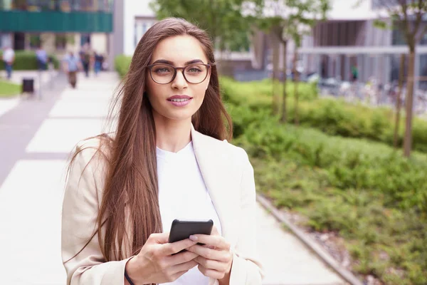 Young businesswoman give a call while walking on the street — Stock Photo, Image